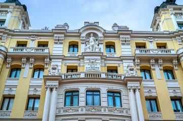 Old facade of a building in Gran Via. It has a sign reading Seguros La Estrella, Madrid, Spain.