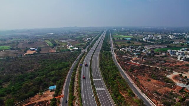 aerial view of vehicles going on nehru outer ring road and sky in hyderabad, telangana. day time, 4k, push in drone shot