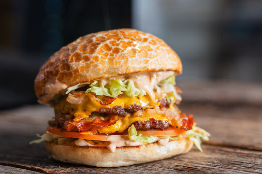 Juicy double cheeseburger with crispy bacon, fresh lettuce, and special sauce, served on a toasted bun.