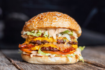 Juicy double cheeseburger with crispy bacon, fresh lettuce, and special sauce, served on a toasted bun.
