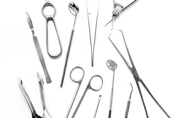 Surgical scissors and forceps. Medical metal hand tools and equipment on white, top view