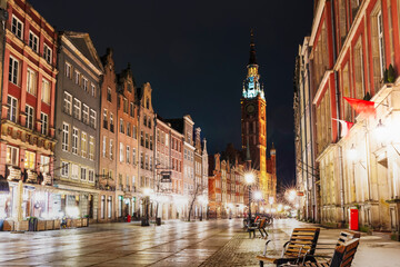 Naklejka premium night Cityscape with lanterns, old buildings and catholic cathedral. Evening European city in winter. Gdansk, Polish city