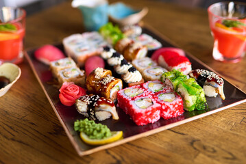 Elegant sushi platter arranged on sleek restaurant table, sushi rolls and sashimi displayed with luxury dining aesthetics, sushi experience enhanced by fine cuisine, creating refined atmosphere