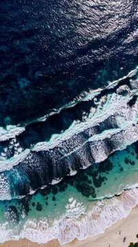 Aerial view of blue, white, turquoise sea with waves rolling and crashing on a white sands beach, Vertical backgrounds
