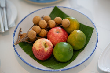 The fruit platter consists of longan, apple and orange.