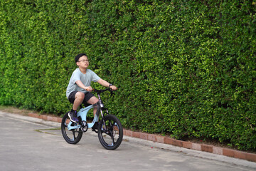 boy cycling bicycle on road