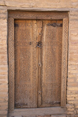 Khiva, Uzbekistan - October 14, 2024: Tash-Khovli Palace (Trsl.  Stone Palace) wooden door