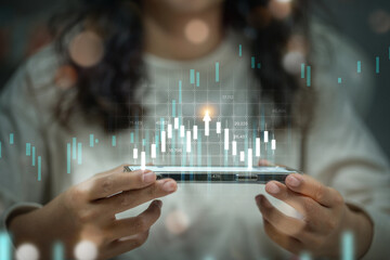 A person holding a smartphone with a digital stock market chart overlay