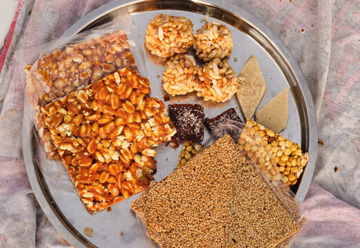Peanut chikki and Til chikki are sweet dishes made with jaggery, peanut and sesame. Murmura laddu, puffed rice laddu, Daliya Chikki (fudge), Indian festival makar Sankranti special sweet. Khajur Pak.