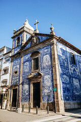 Porto, Portugal - December 28, 2024: Chapel of Souls (Capela das Almas de Santa Catarina), famous for its exterior of blue and white tiles painted with scenes from the lives of saints.