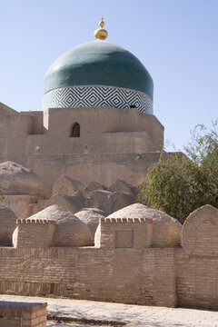 Khiva, Uzbekistan - October 14, 2024: Khiva, Uzbekistan - October 14, 2024:  Pahlavan Mahmud Mausoleum with other grave tumbs infront