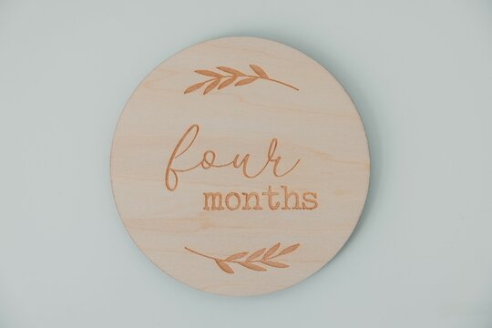 Wooden milestone disc with botanical design