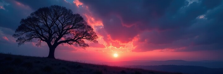 Obraz premium Tree branches stretch towards the darkening sky, lone, branchless, solitary