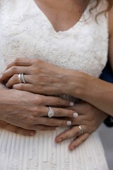 Bride and groom's hands with wedding rings.