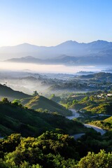 Obraz premium A scenic mountain view obstructed by smog drifting from urban areas.