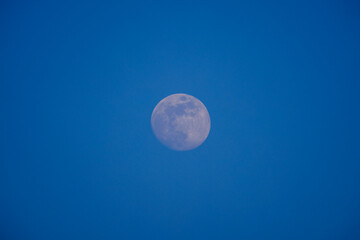the moon against the blue sky