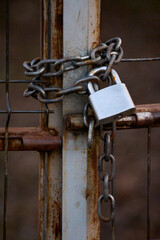 a chain with a padlock closed on a gate