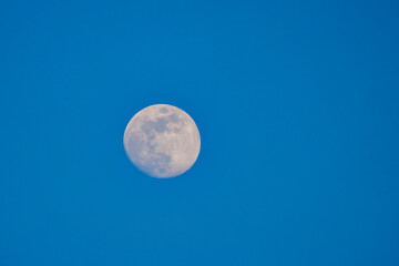 the moon against the blue sky