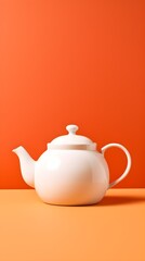 Elegant White Teapot on Vibrant Orange Background Perfect for Kitchen or Home Decor