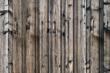 Weathered wooden planks reveal history through texture and color in sunlight