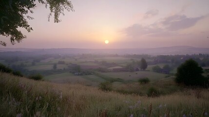Serene Sunset Over Rolling Fields with Shades of Pink and Purple
