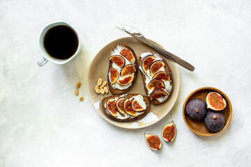 Healthy vegetarian meal snack on the table - fig sandwiches with cheese and honey, top view
