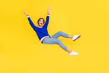 Full length photo of shiny cheerful lady dressed knitted sweater rising hands arms falling down...