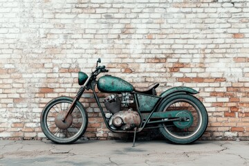 A rusty teal vintage motorcycle leans against a weathered brick wall, evoking a sense of nostalgia and classic style.