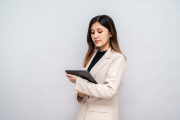 Fototapeta premium Businesswoman Using Digital Tablet with Stylus for Work,Professional Woman Writing on a Tablet in a Corporate Setting
