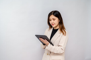 Fototapeta premium Businesswoman Using Digital Tablet with Stylus for Work,Professional Woman Writing on a Tablet in a Corporate Setting