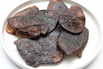 Burnt scorched pancakes,cookies on baking frying pan,plate.overcooked,spoiled food,violation of cooking technology,not properly stored,health hazard