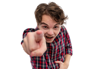 A young man in a checkered shirt pointing at the camera with a playful expression.