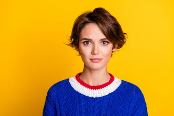 Photo portrait of attractive young woman look camera dressed stylish blue knitted clothes isolated on yellow color background