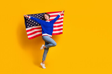 Full length photo of funky excited lady dressed knitted sweater holding american flag empty space...