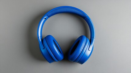Blue headphones on grey background, music listening, studio shot, advertising