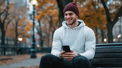 Young man enjoying time on park bench autumn vibes mobile connection loveconnected moments