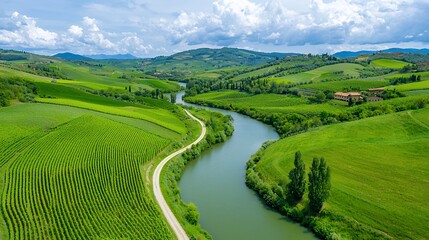 Fototapeta premium Aerial View Of Serpentine River Meandering Through Verdant Vineyards And Rolling Hills