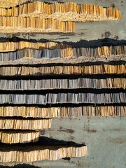 Aerial view of chopped tree wood log stacks in a row