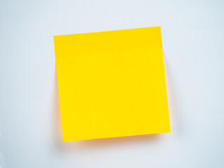 Bright yellow sticky note on a plain background