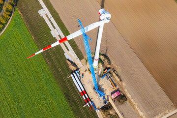 Construction site of wind power plant installation. Aerial view rotor blade installation in...