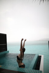 Young blonde woman when raining in maldives