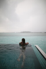 Young blonde woman when raining in maldives