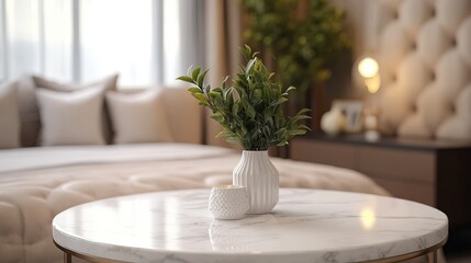 Close up of a white vase containing a green plant on a white marble table surface