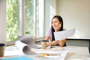 Female comfortably settled in her workplace in a bright room