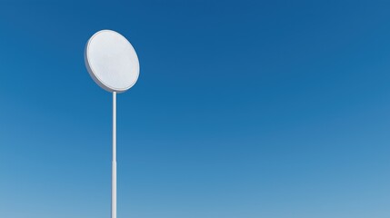 Circular signpost under clear blue sky
