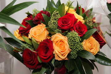  Bouquet of red and yellow roses in a vase.