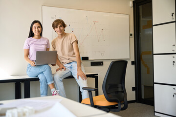 Fototapeta premium Young colleagues are happy with the results of their work