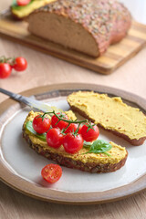 Healthy hummus toast served on white plate with rustic decoration. Vegan concept, healthy eating