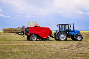 Agricultural machinery, tractors and combines working on the field.