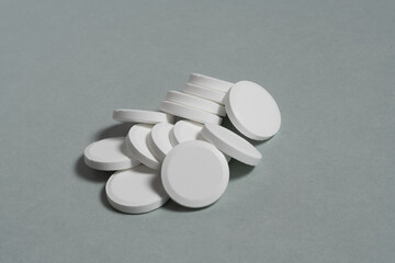 Heap of round calcium tablets taken as supplement. Copy Space.